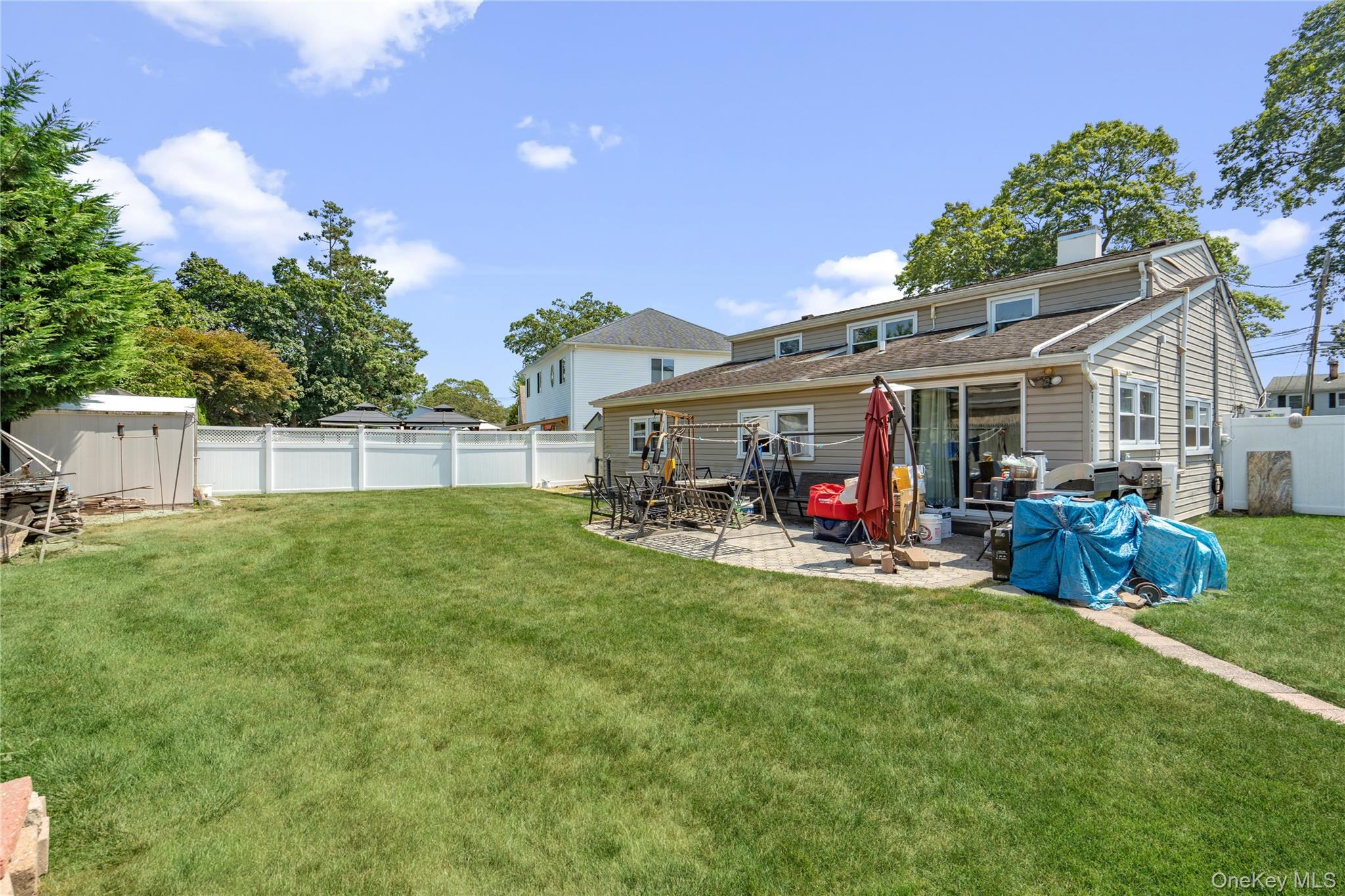 9 Rugby Road Massapequa, NY 11758 - Photo 22 of 33 a view of a house with a backyard and a patio