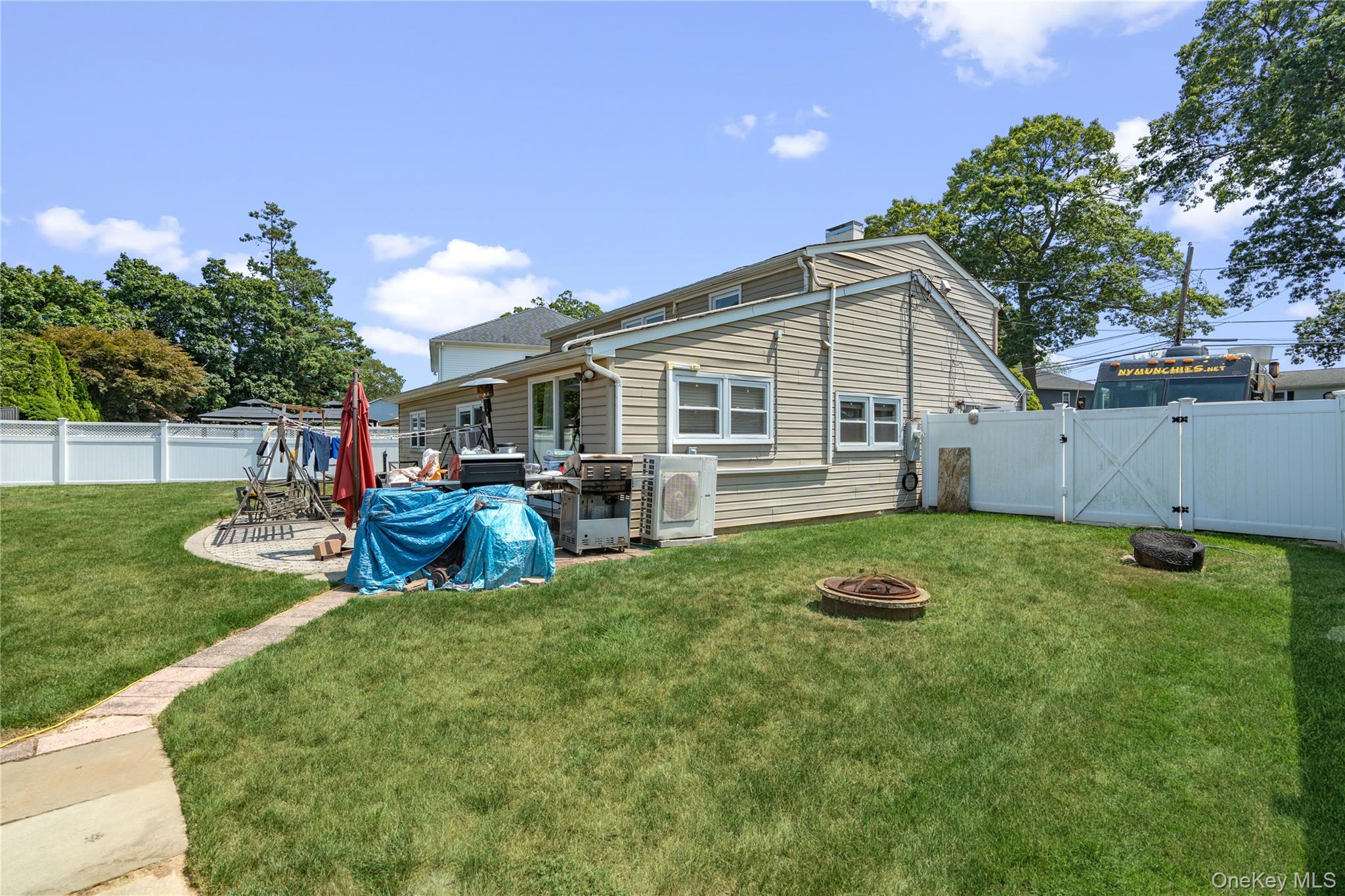 9 Rugby Road Massapequa, NY 11758 - Photo 26 of 33 a view of a house with backyard porch and sitting area