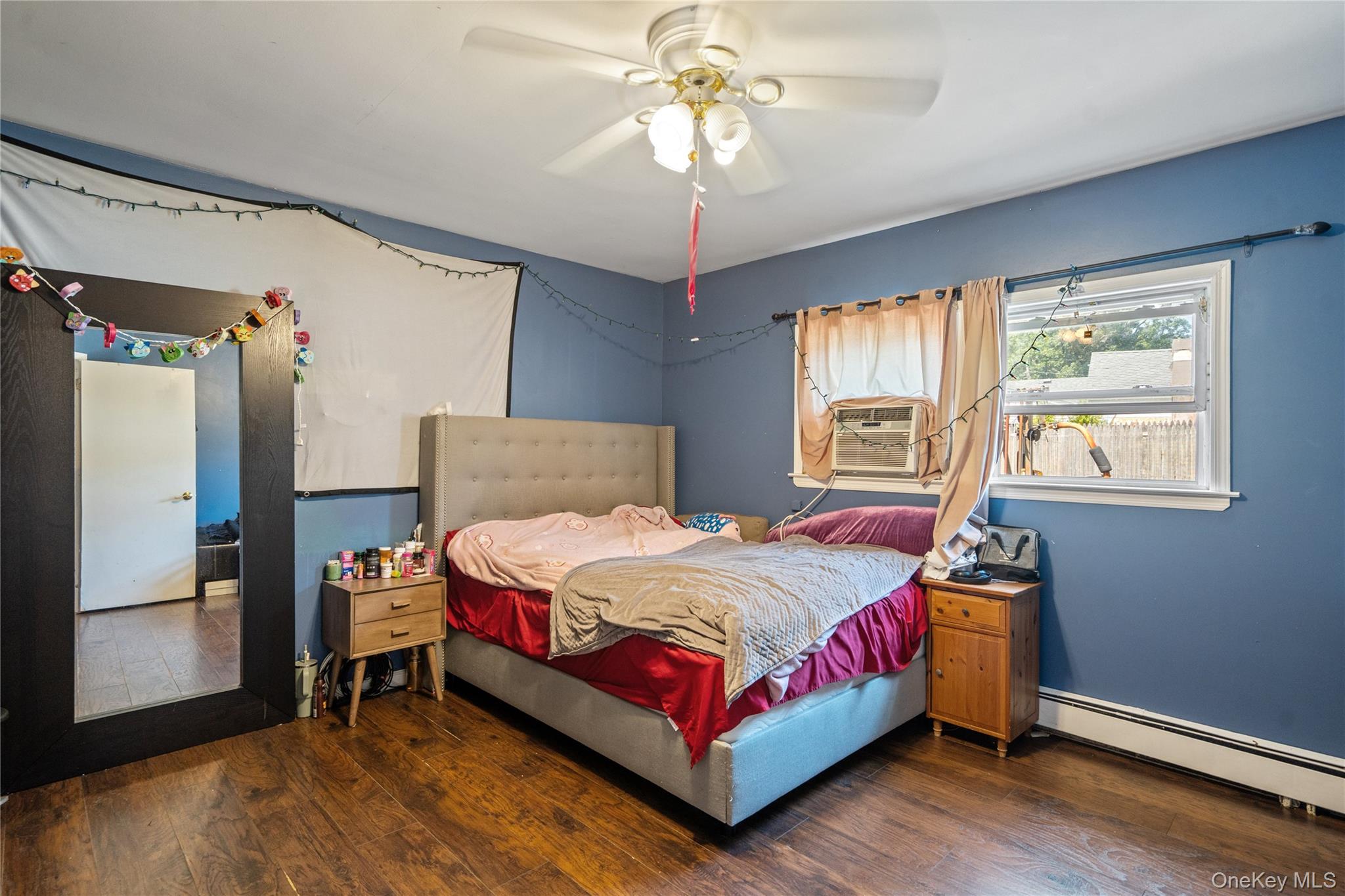 9 Rugby Road Massapequa, NY 11758 - Photo 8 of 33 a bedroom with a bed and a chandelier