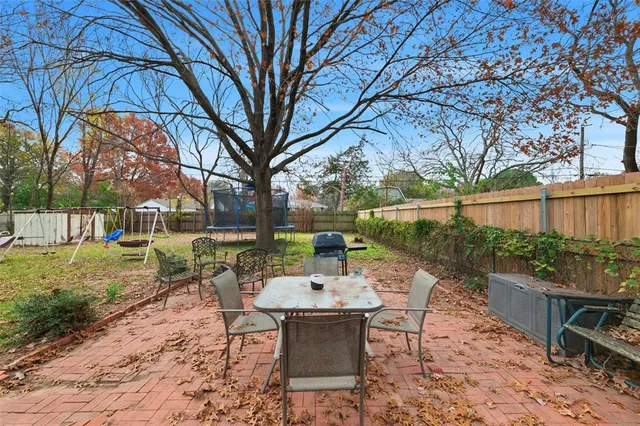a view of a patio with table and chairs and potted plants