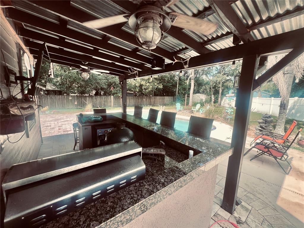 357 Tymber Run Ormond Beach, FL 32174 - Photo 26 of 32 a view of a patio with a table chairs and a barbeque
