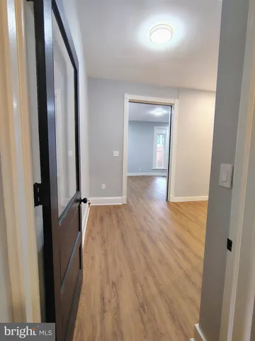a view of hallway with wooden floor