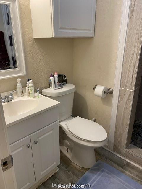 3005 1st Street Bryan, TX 77801 - Photo 12 of 18 a bathroom with a sink toilet and vanity