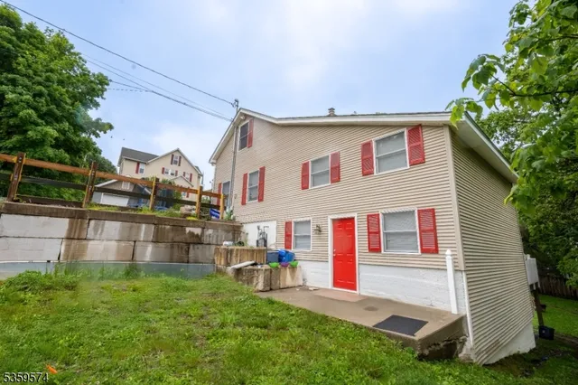 a view of backyard with table and chairs and potted plants