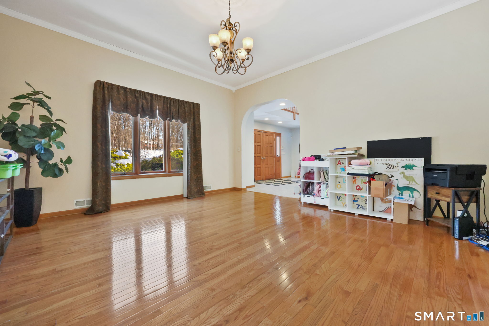 41 Ridge Line Road Easton, CT 06612 - Photo 12 of 40 a dining room with wooden floor a chandelier a glass table and chairs