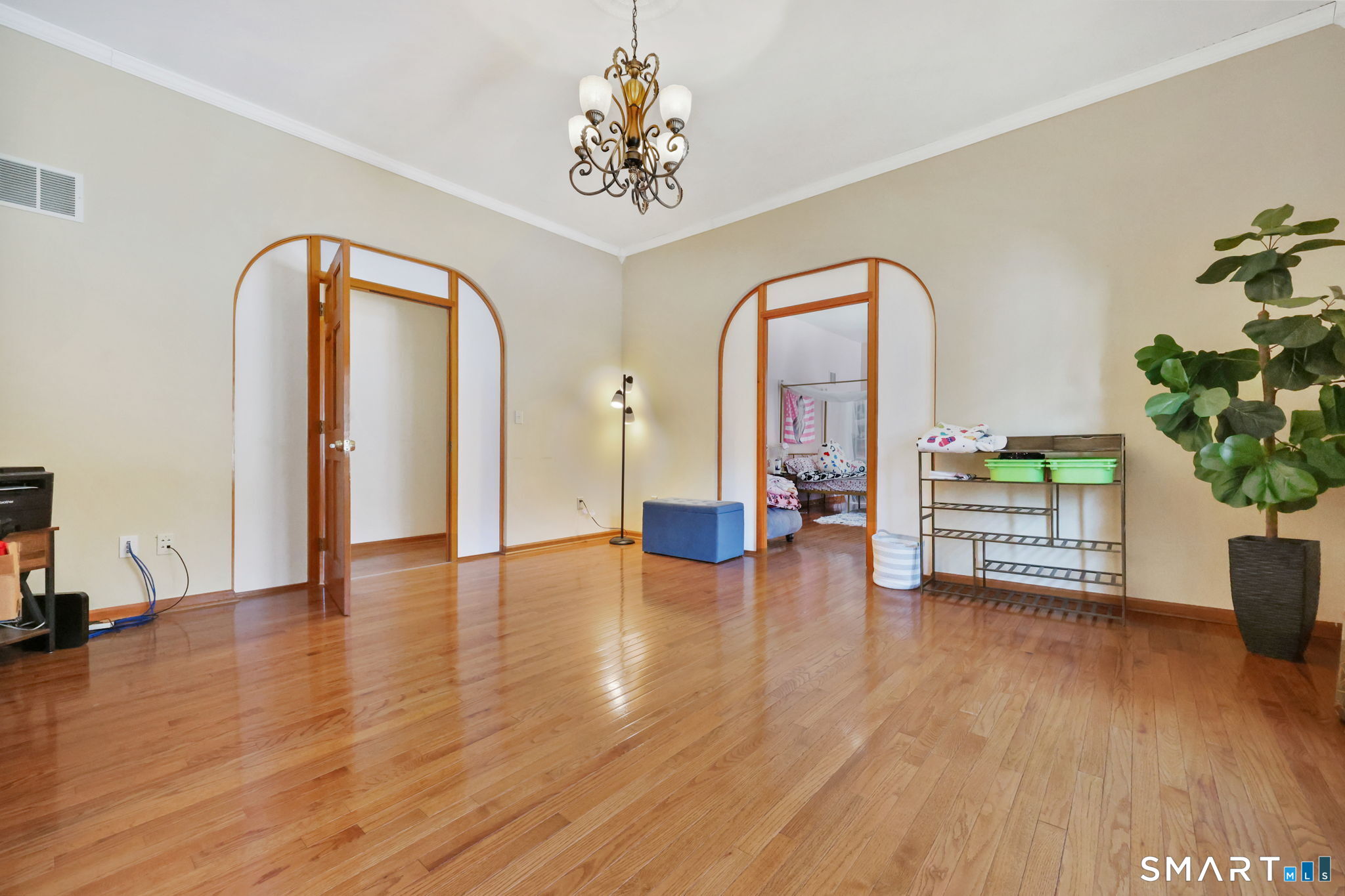 41 Ridge Line Road Easton, CT 06612 - Photo 14 of 40 a view of an empty room with wooden floor and a potted plant