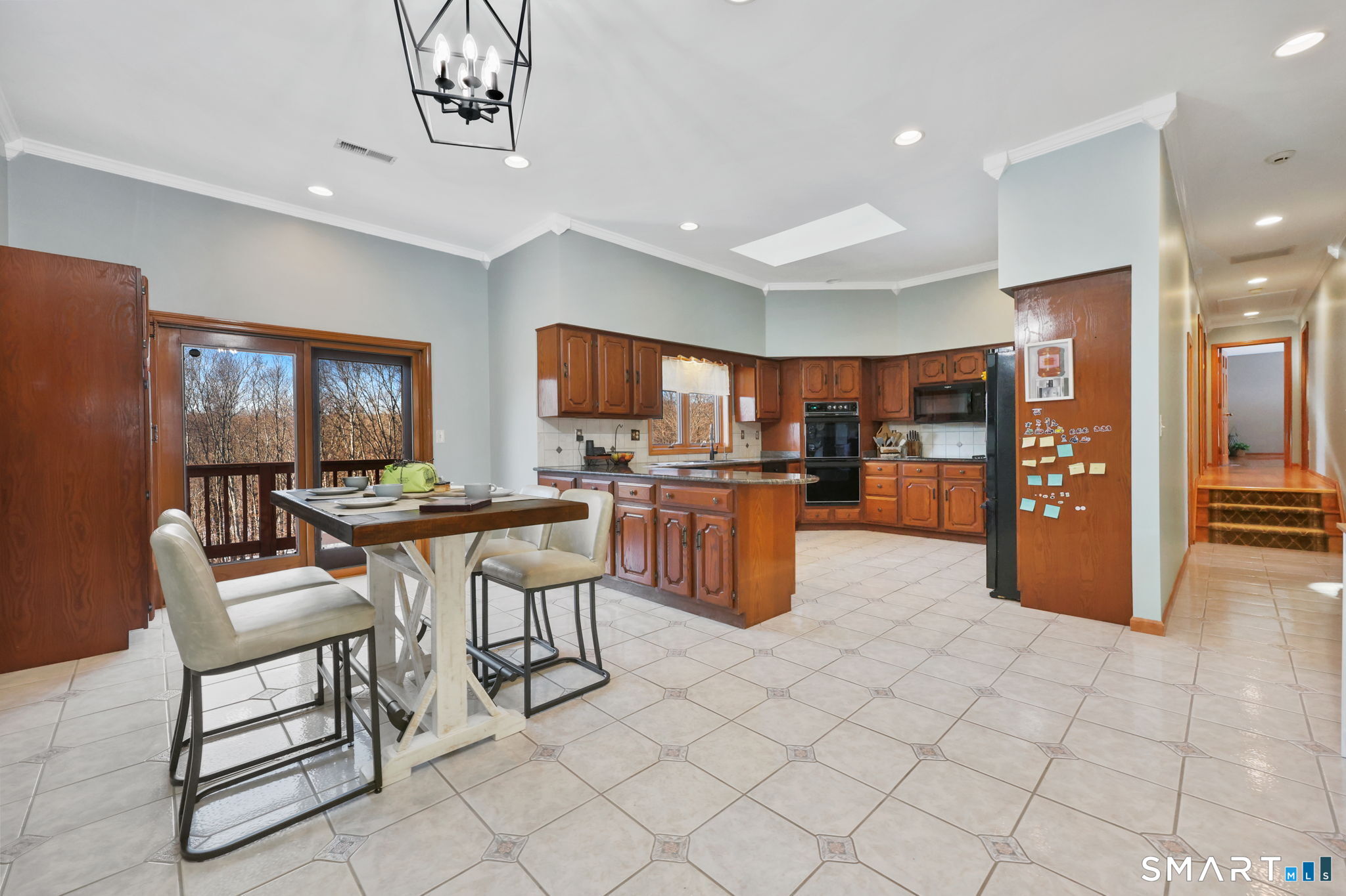 41 Ridge Line Road Easton, CT 06612 - Photo 23 of 40 a kitchen with stainless steel appliances kitchen island granite countertop a refrigerator cabinets and chairs