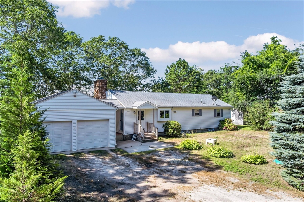 9 Point Road Mashpee, MA 02649 - Photo 1 of 27 a front view of a house with garden
