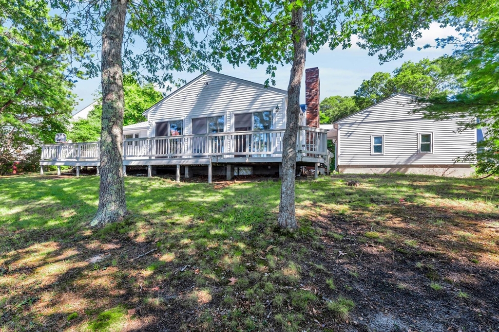 9 Point Road Mashpee, MA 02649 - Photo 11 of 27 a aerial view of a house next to a big yard and large trees