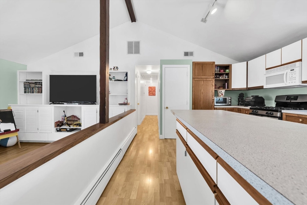 9 Point Road Mashpee, MA 02649 - Photo 17 of 27 a living room with stainless steel appliances furniture a flat screen tv and a view of kitchen