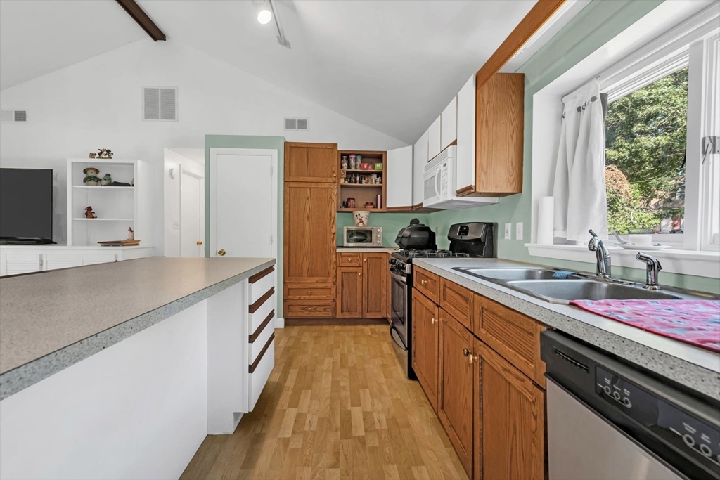9 Point Road Mashpee, MA 02649 - Photo 18 of 27 a kitchen with stainless steel appliances granite countertop a sink stove and refrigerator