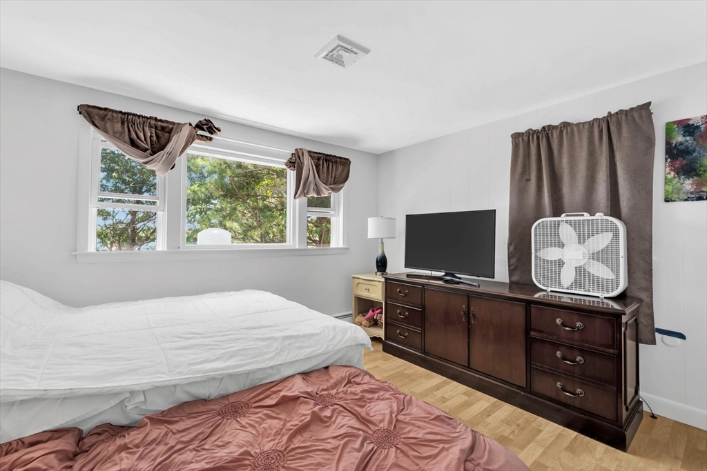 9 Point Road Mashpee, MA 02649 - Photo 19 of 27 a bedroom with a bed and a television