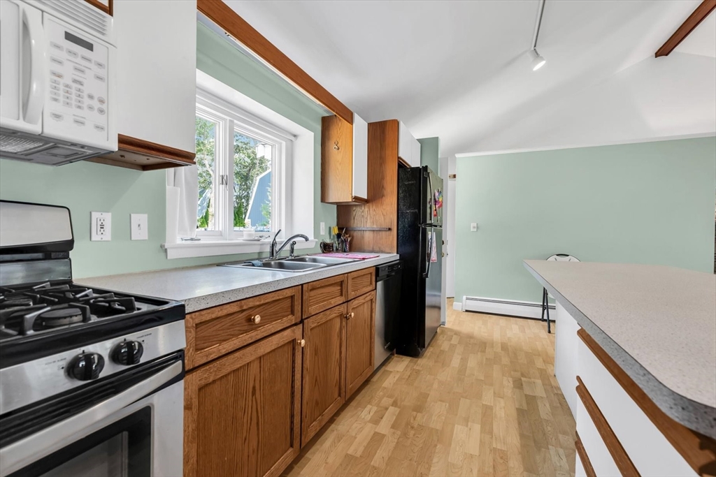 9 Point Road Mashpee, MA 02649 - Photo 24 of 27 a kitchen with stainless steel appliances granite countertop a sink stove and cabinets
