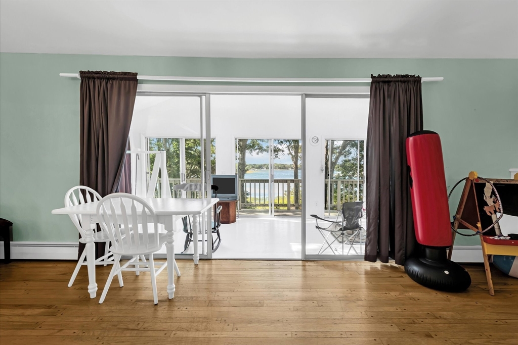 9 Point Road Mashpee, MA 02649 - Photo 8 of 27 a view of a dining room with furniture water view and wooden floor