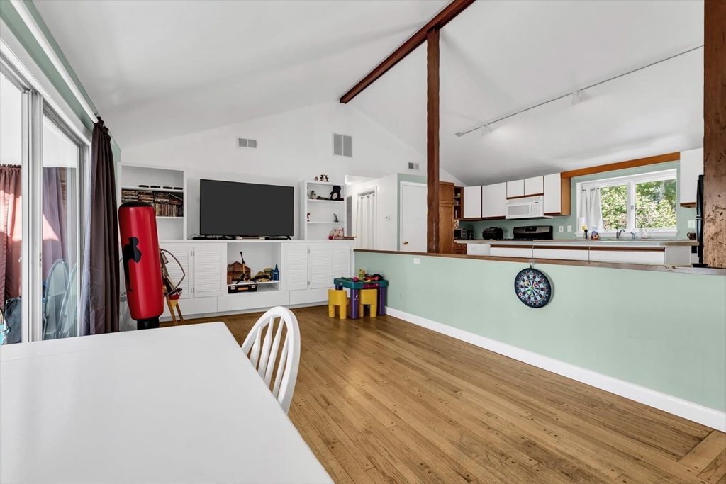 9 Point Road Mashpee, MA 02649 - Photo 9 of 27 a kitchen with stainless steel appliances granite countertop a refrigerator a stove a microwave oven a sink with island and chairs