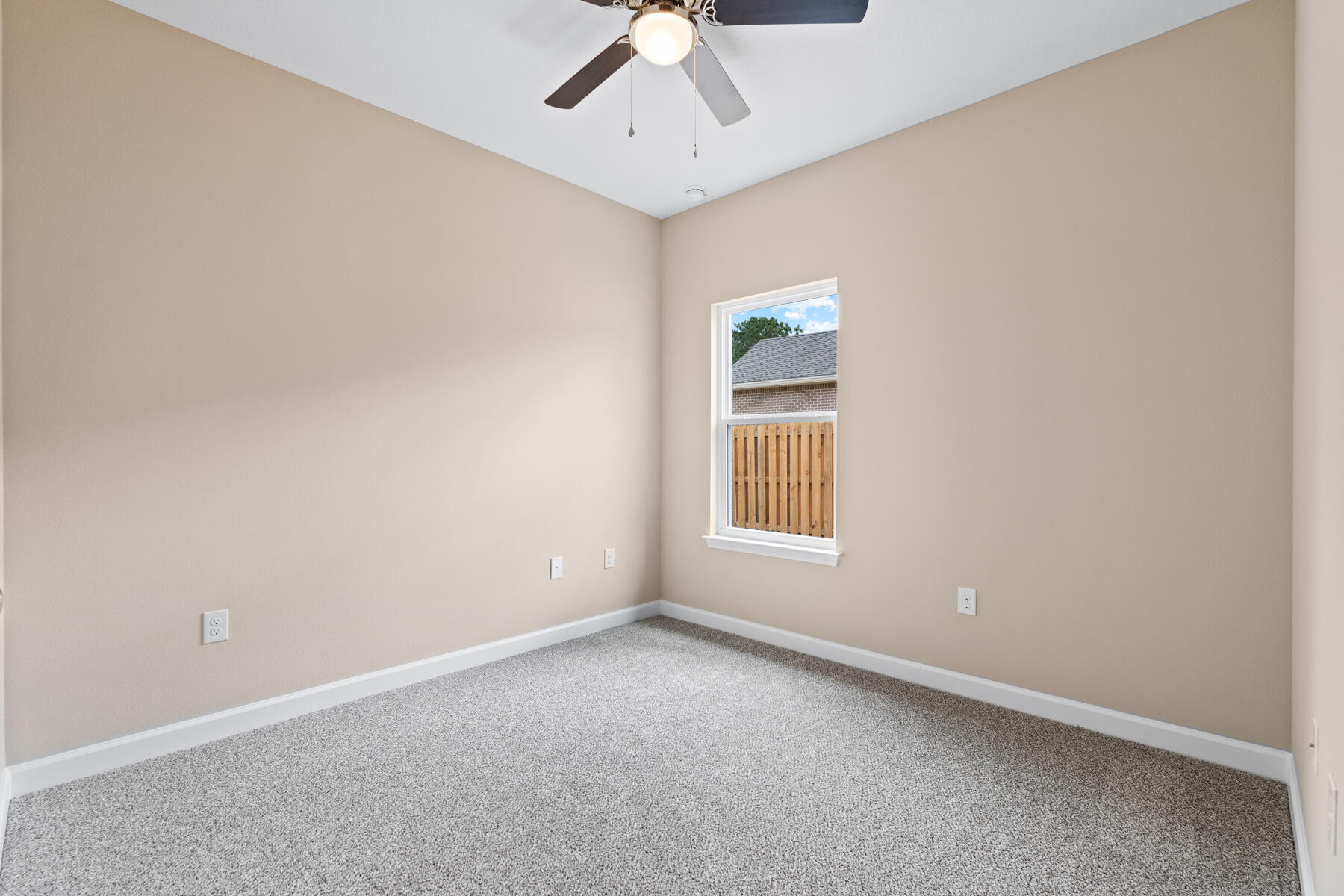 6011 Sand Hill Road Crestview, FL 32539 - Photo 11 of 16 an empty room with a chandelier fan and windows
