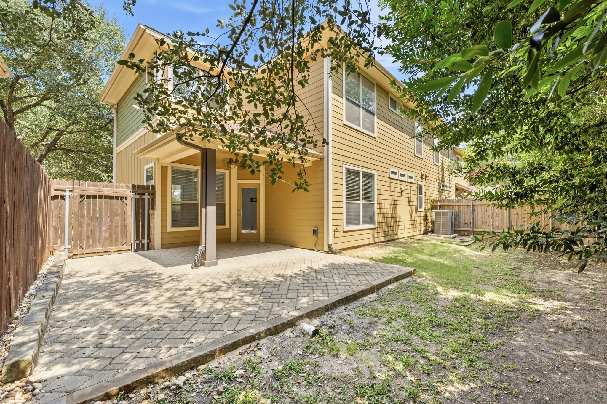 6708 Manchaca Road, Unit 4 Austin, TX 78745 - Photo 23 of 25 An inviting paved patio overlooks the fenced backyard shaded by mature trees.