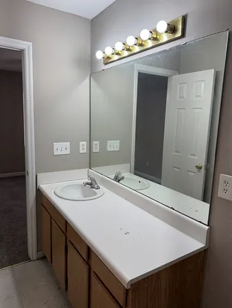a bathroom with a sink and a mirror