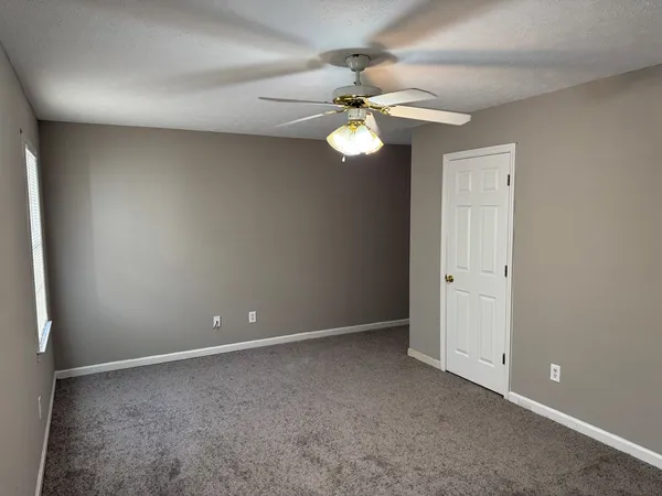 a view of an empty room with a fan
