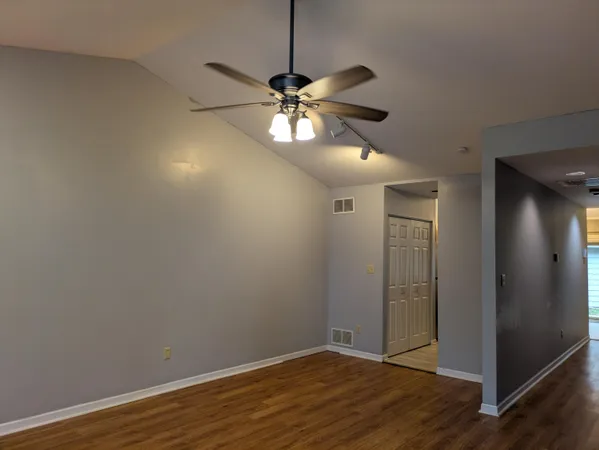 a view of a chandelier fan and wooden floor