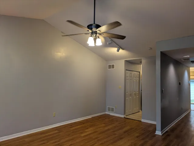 a view of a chandelier fan and wooden floor