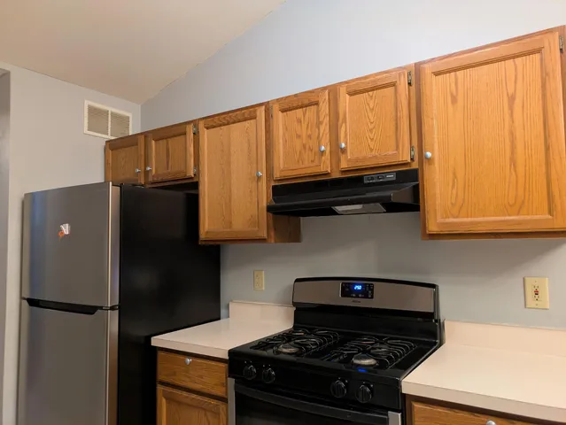 a kitchen with a stove and a refrigerator