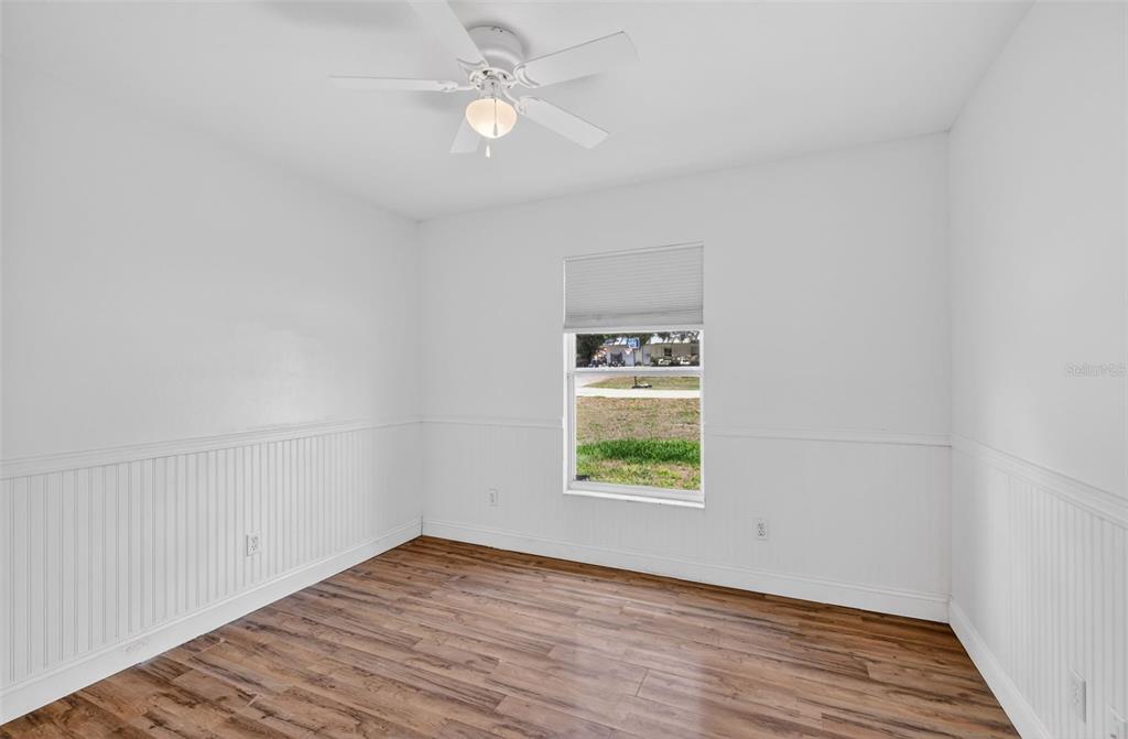 36 Bay Ridge Loop Mascotte, FL 34753 - Photo 21 of 32 an empty room with wooden floor chandelier fan and windows