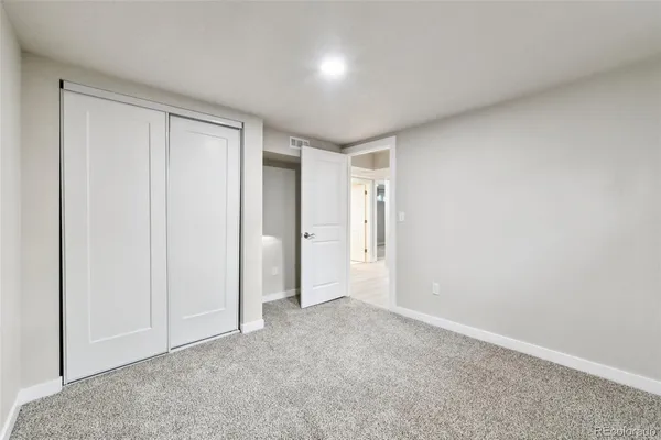 a view of an empty room and closet area