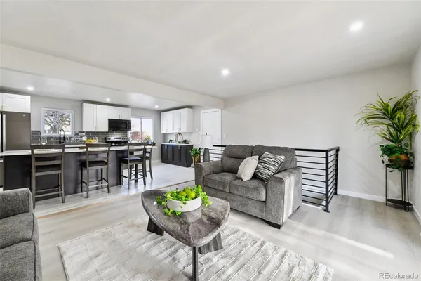 a living room with furniture and kitchen view