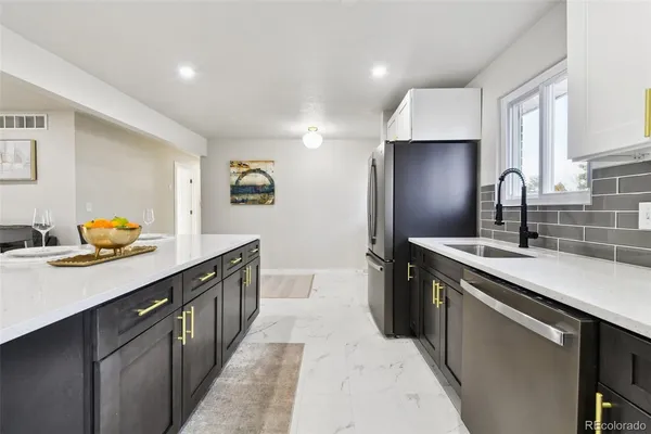 a kitchen with stainless steel appliances a sink stove and cabinets
