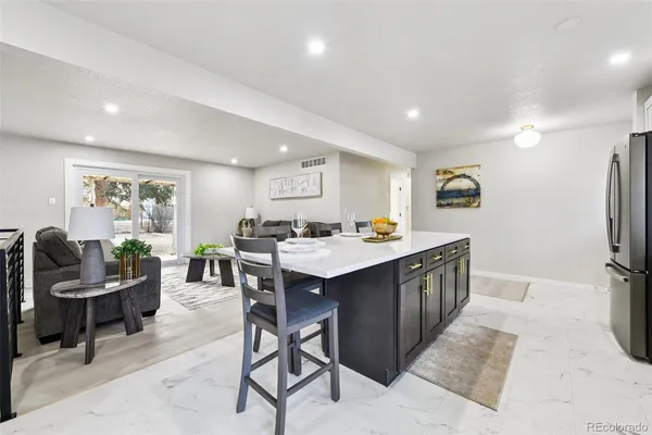 a kitchen with a sink cabinets and wooden floor