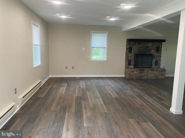 123 Oakdale Avenue Washington Crossing, PA 18977 - Photo 4 of 13 an empty room with wooden floor a fireplace and windows