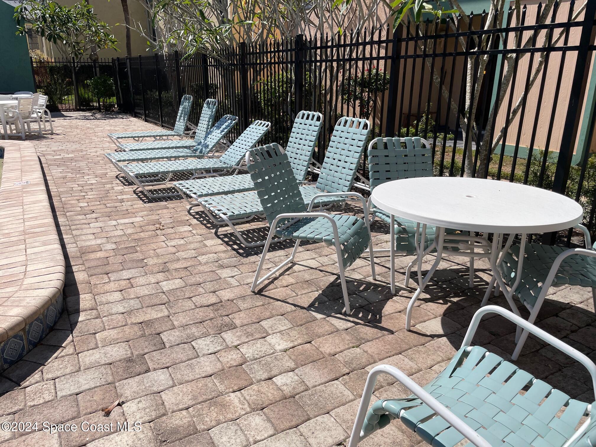 1225 North Wickham Road, Unit 415 Melbourne, FL 32935 - Photo 29 of 34 Community Pool Sitting Area