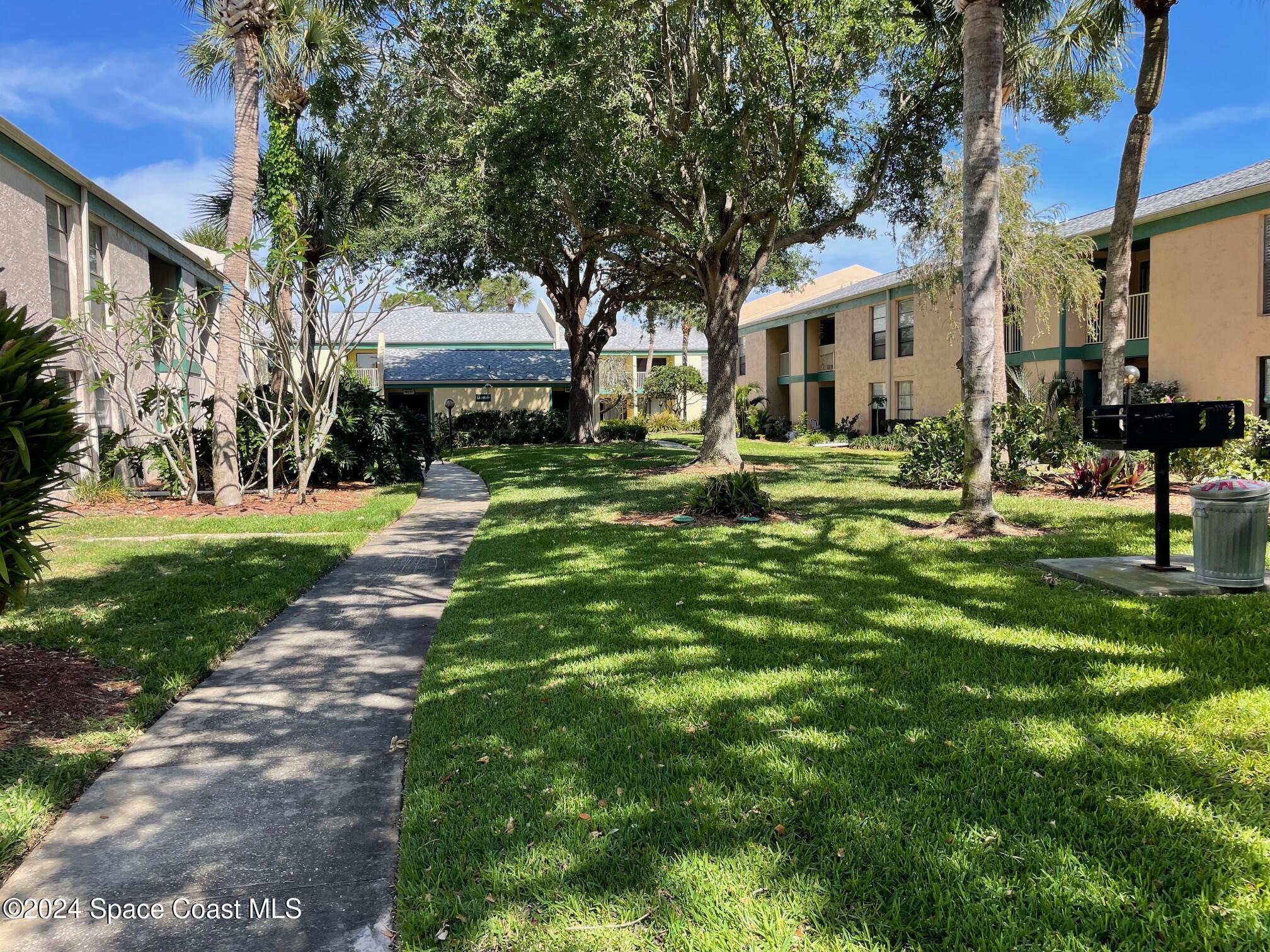 1225 North Wickham Road, Unit 415 Melbourne, FL 32935 - Photo 33 of 34 WALK FROM THE POOL BACK TO CONDO