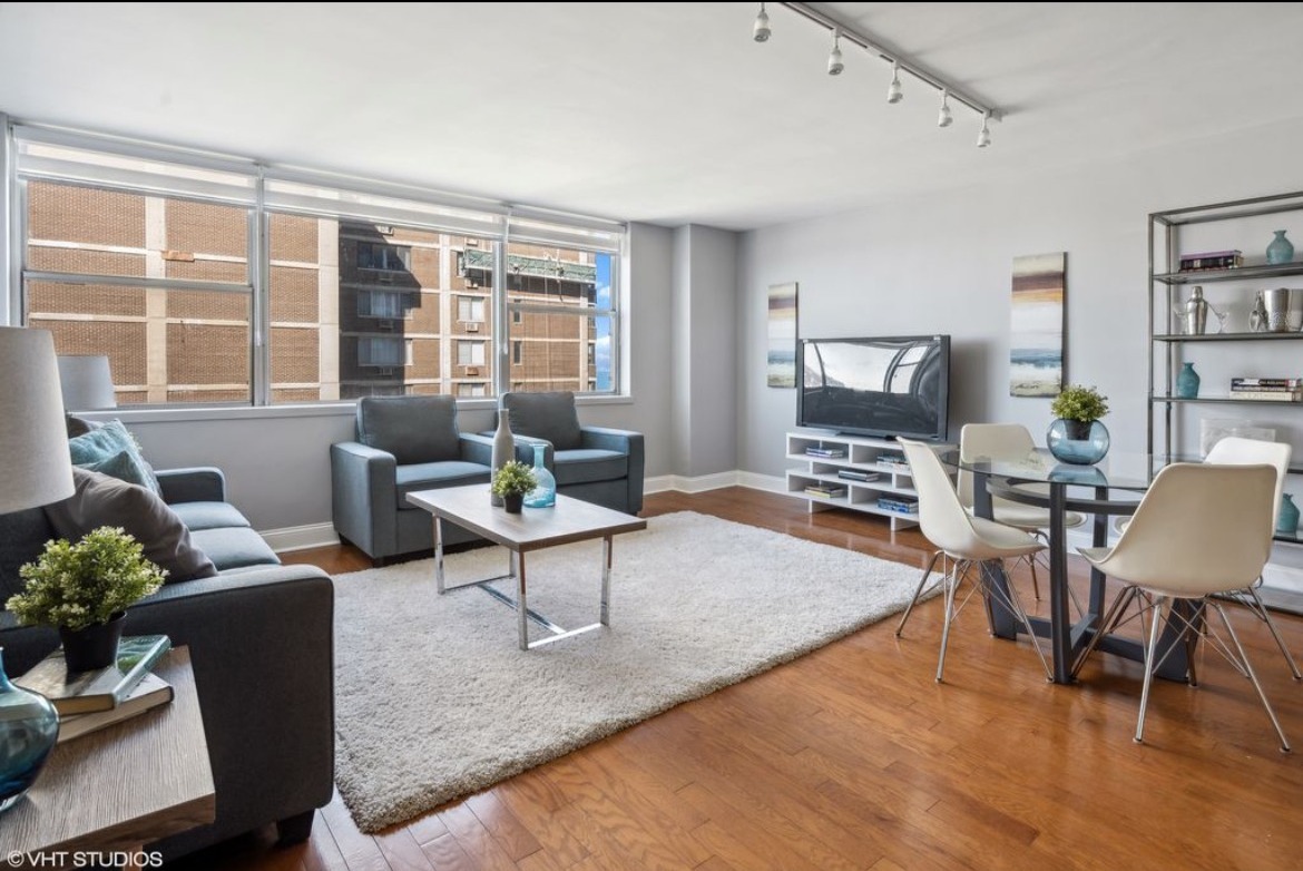 6301 North Sheridan Road, Unit 19D Chicago, IL 60660 - Photo 3 of 11 a living room with furniture and a flat screen tv