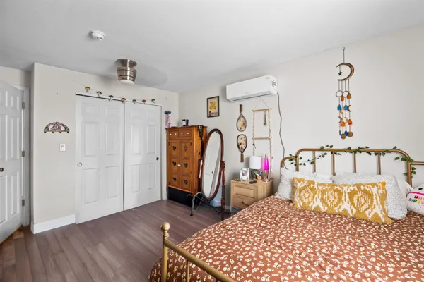 a bedroom with furniture and wooden floor
