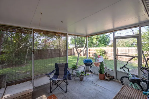 a view of a room with furniture and floor to ceiling window