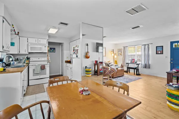 a living room with furniture and kitchen view
