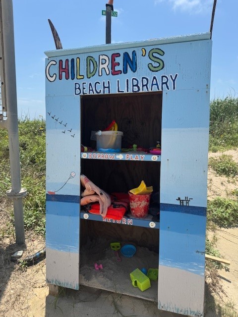 0 Crystal Beach Road Crystal Beach, TX 77650 - Photo 6 of 18 This photo shows a charming "Children's Beach Library" near a sandy beach, offering toys for kids to borrow and play with. It's a delightful community feature that highlights the family-friendly nature of the area.