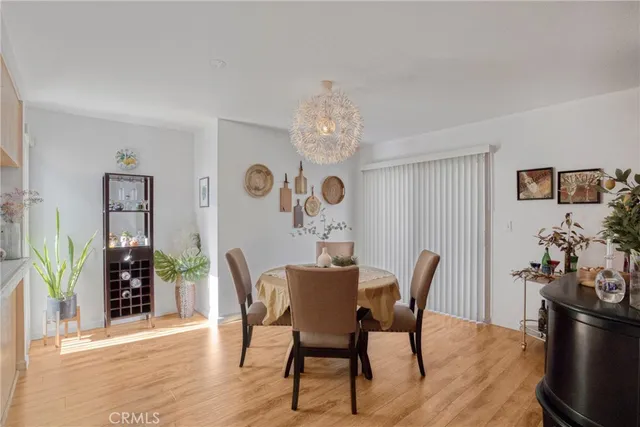 a dining room with furniture potted plants and wooden floor