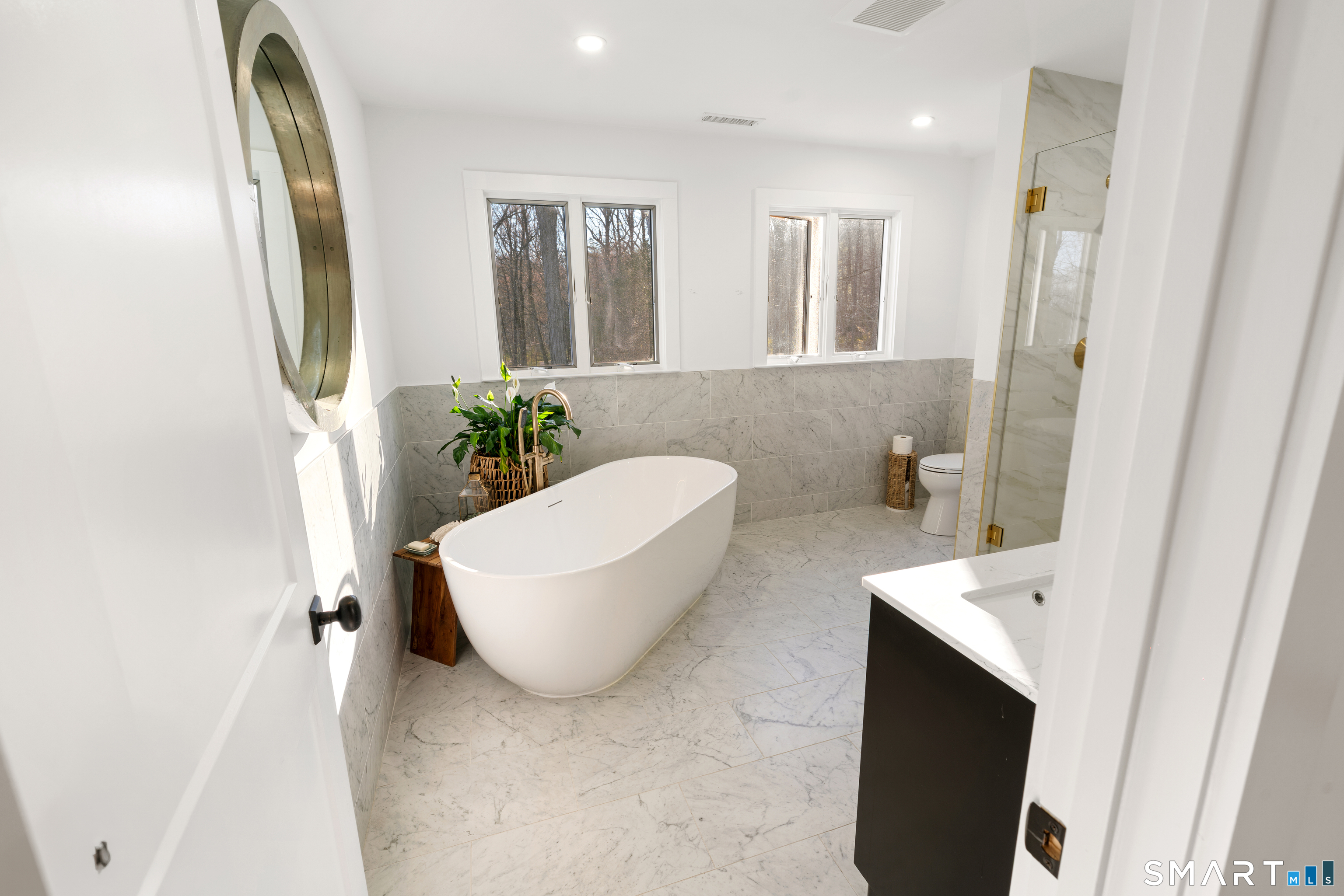 23 Norton Road Easton, CT 06612 - Photo 24 of 40 Two large windows frame the soaking tub, bringing in natural light and serene views.