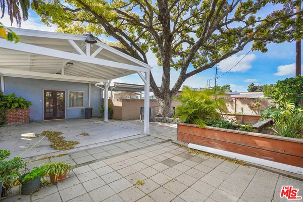 a front view of a house with a tree