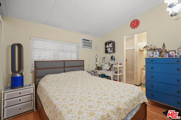 a bedroom with a bed and a dresser