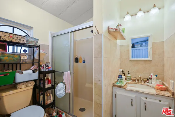 a bathroom with a sink vanity mirror and toilet