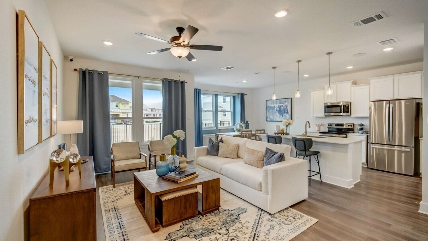 a living room with furniture and a large window