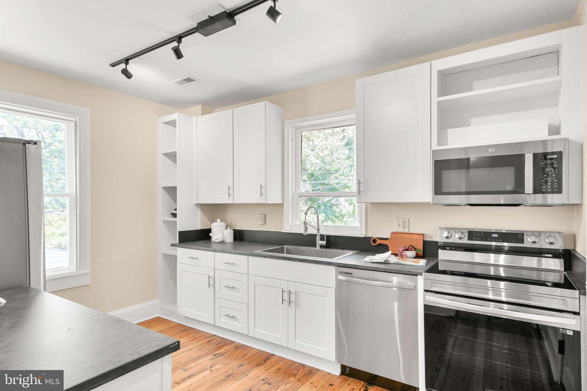 23 West 4th Street Frederick, MD 21701 - Photo 14 of 105 a kitchen with stainless steel appliances granite countertop a sink a stove and cabinets