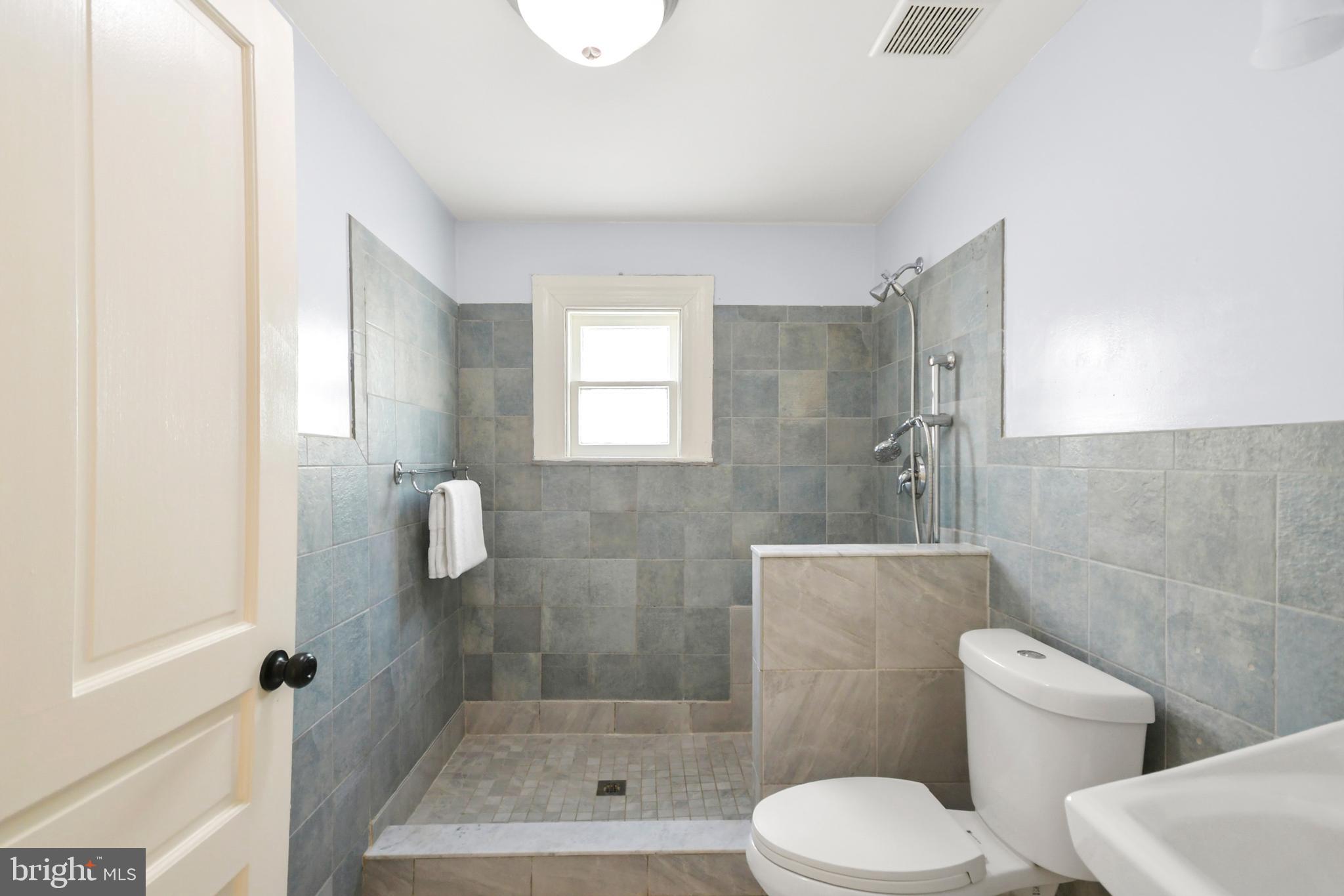 23 West 4th Street Frederick, MD 21701 - Photo 40 of 105 a bathroom with a toilet and a shower