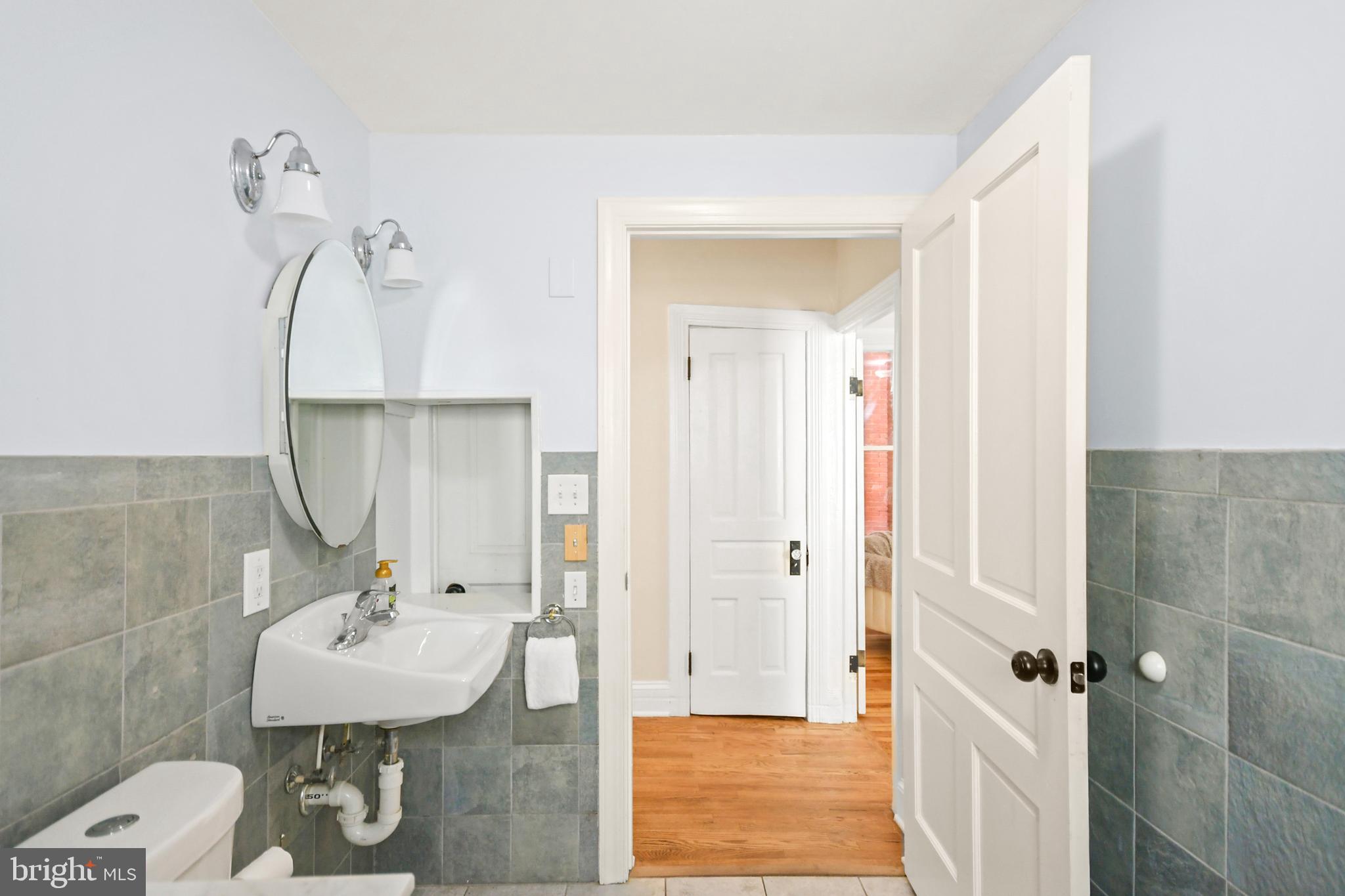 23 West 4th Street Frederick, MD 21701 - Photo 43 of 105 a bathroom with a sink a toilet and shower