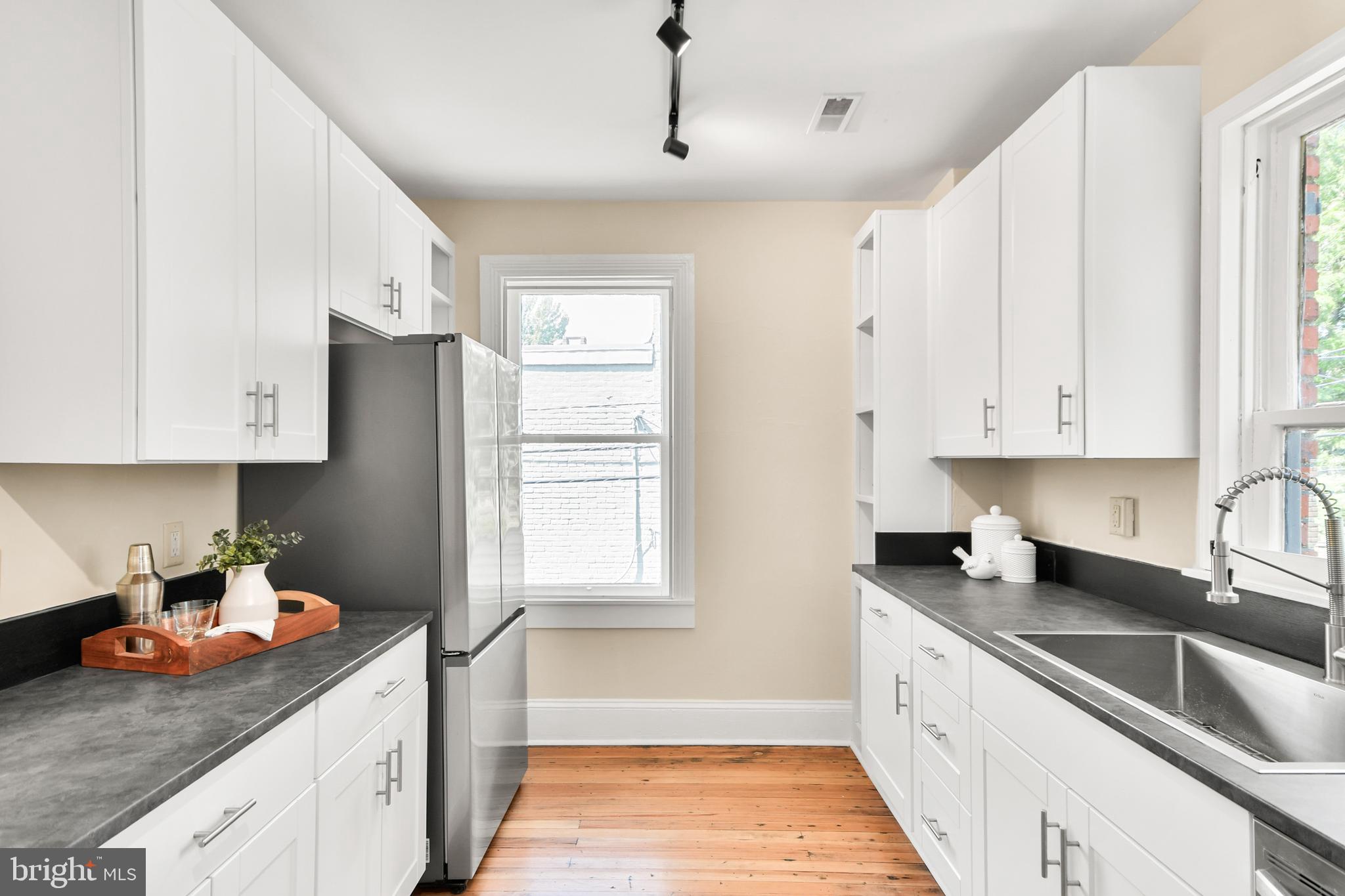 23 West 4th Street Frederick, MD 21701 - Photo 69 of 105 a kitchen with stainless steel appliances granite countertop a sink stove and cabinets