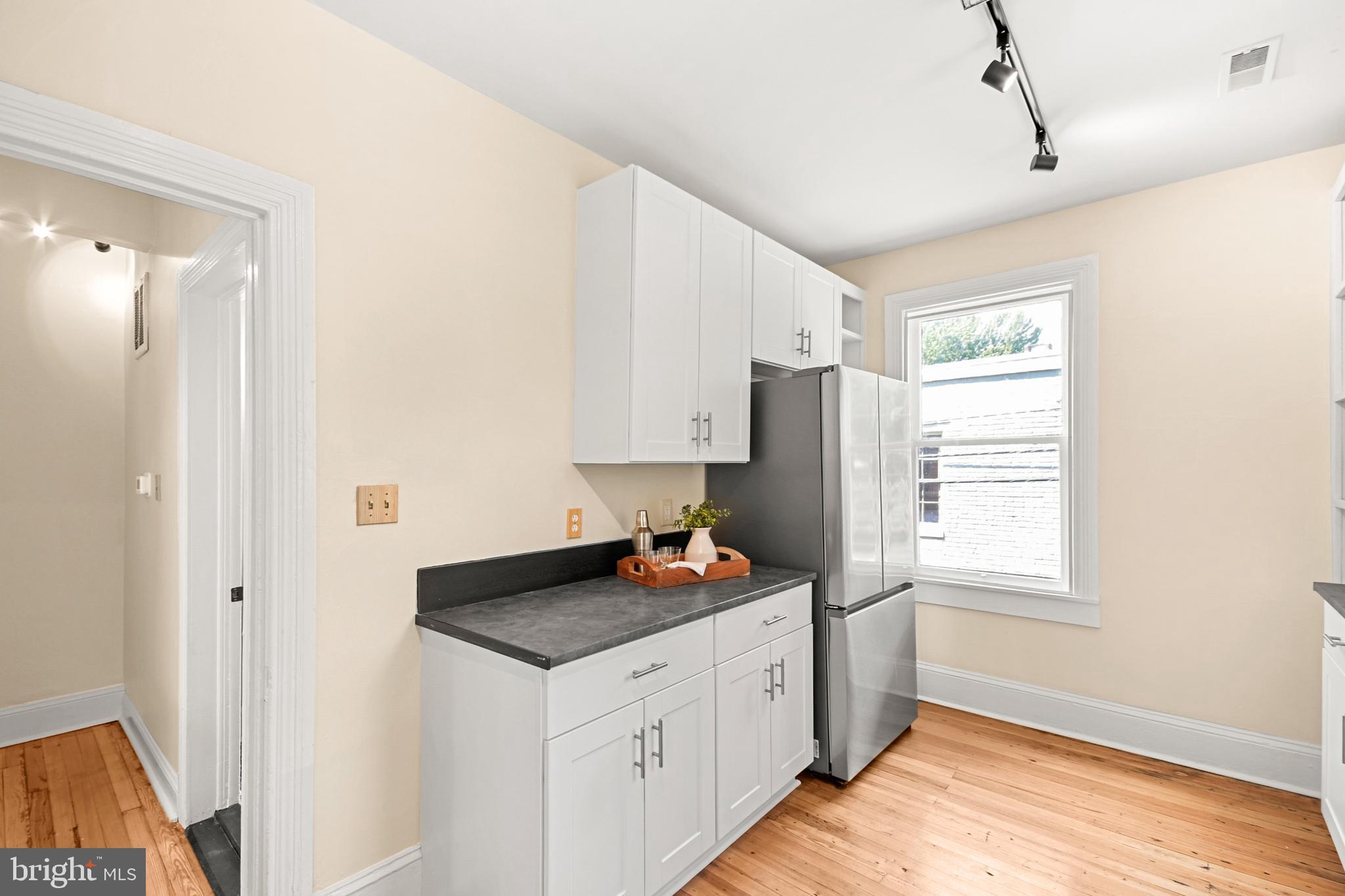 23 West 4th Street Frederick, MD 21701 - Photo 72 of 105 a kitchen with granite countertop cabinets stainless steel appliances a sink and a window